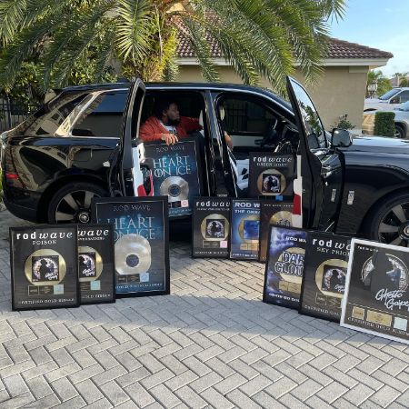 Rodarius Marcell Green took a picture as he posed with his album covers and his car.